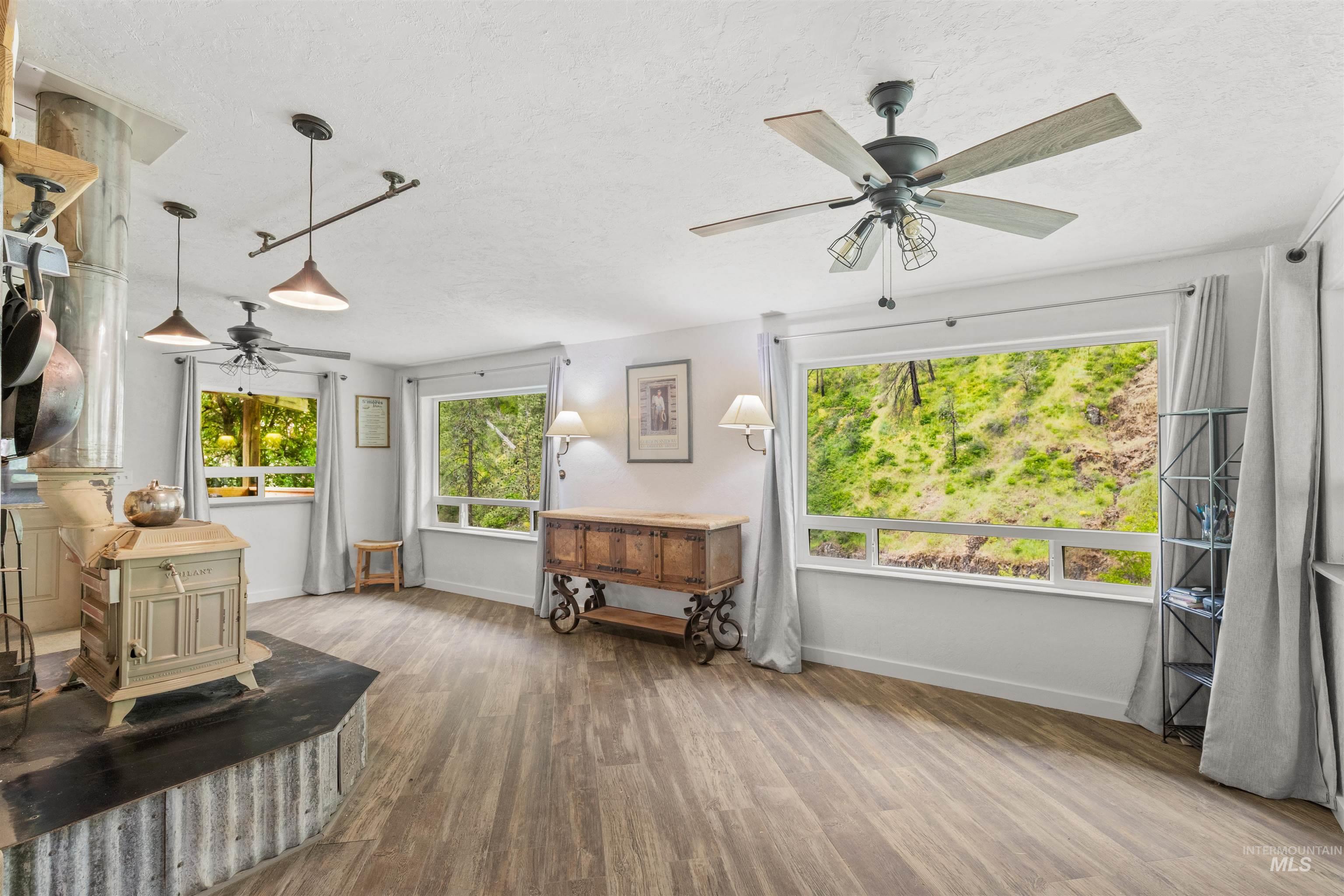 1314 Cedar Ridge Road Kendrick, ID 83537 - Photo 23 of 50 Spacious interior featuring wood-finish flooring, white walls, and multiple large windows