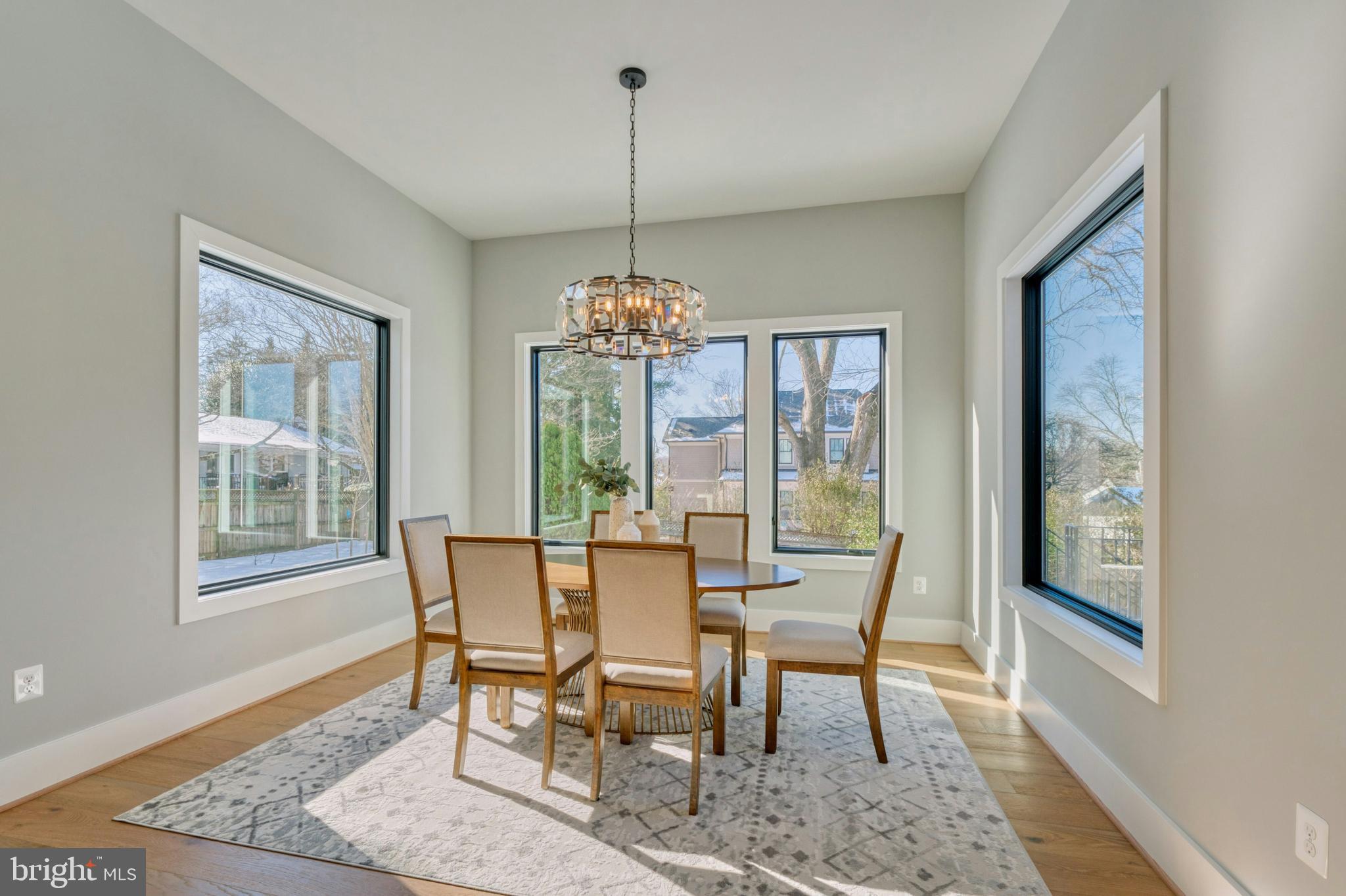 1100 Balls Hill Road McLean, VA 22101 - Photo 14 of 52 a dining room with furniture a chandelier and wooden floor