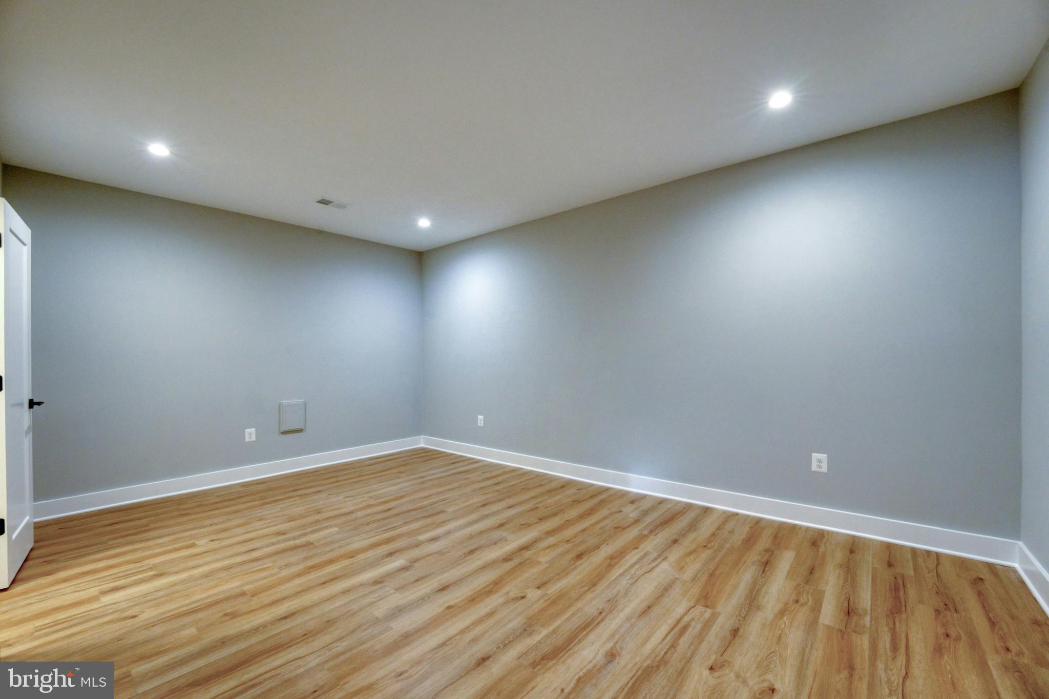 1100 Balls Hill Road McLean, VA 22101 - Photo 32 of 52 an empty room with wooden floor and windows