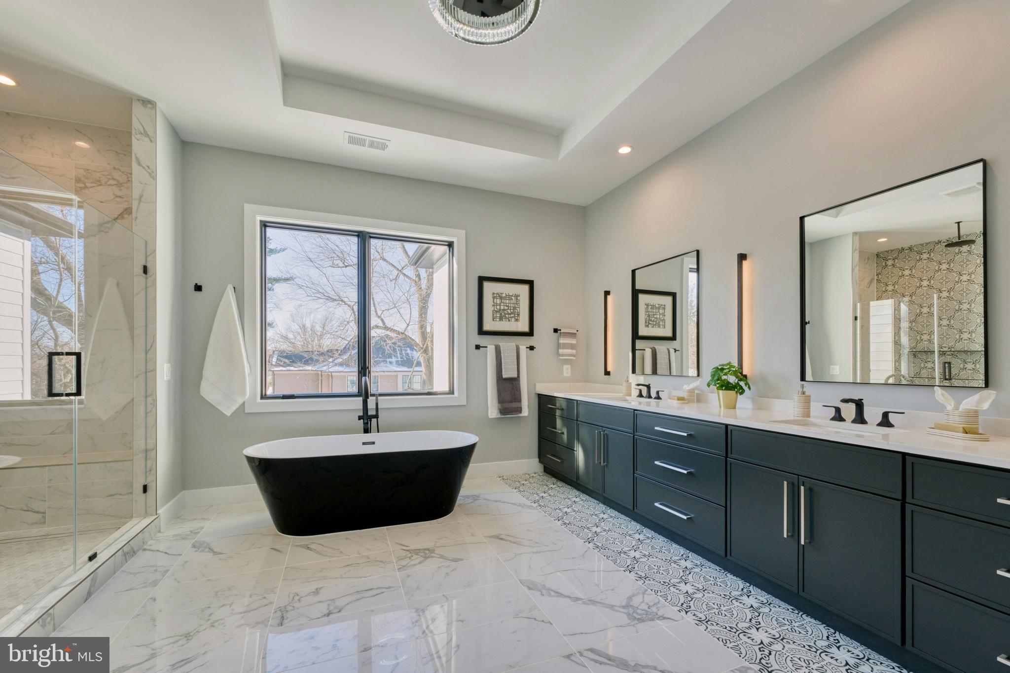 1100 Balls Hill Road McLean, VA 22101 - Photo 36 of 52 a spacious bathroom with a bathtub sink and mirror
