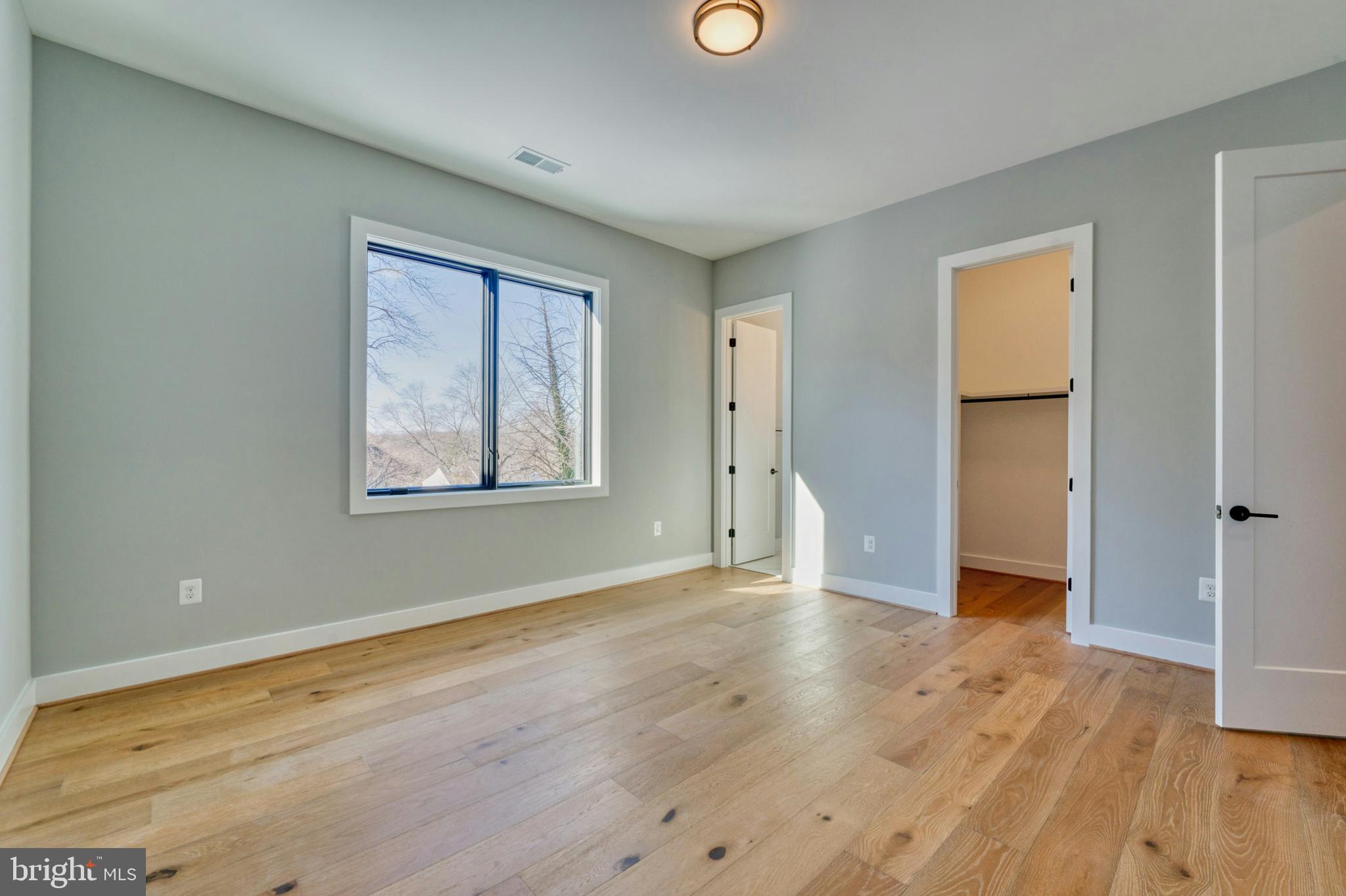 1100 Balls Hill Road McLean, VA 22101 - Photo 38 of 52 a view of an empty room with wooden floor and a window