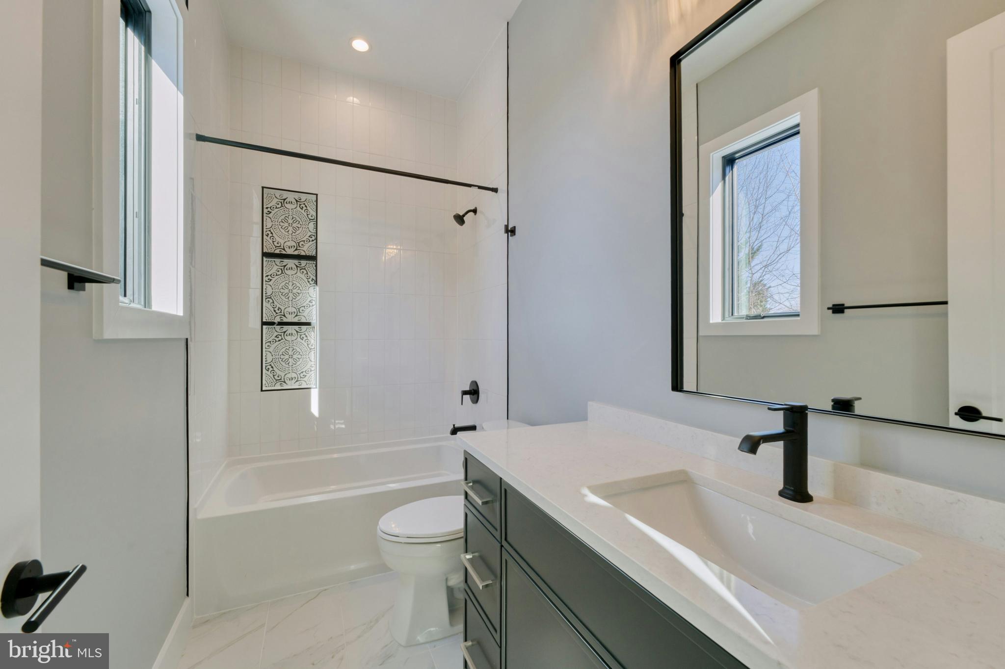 1100 Balls Hill Road McLean, VA 22101 - Photo 39 of 52 a bathroom with a granite countertop sink a toilet and shower