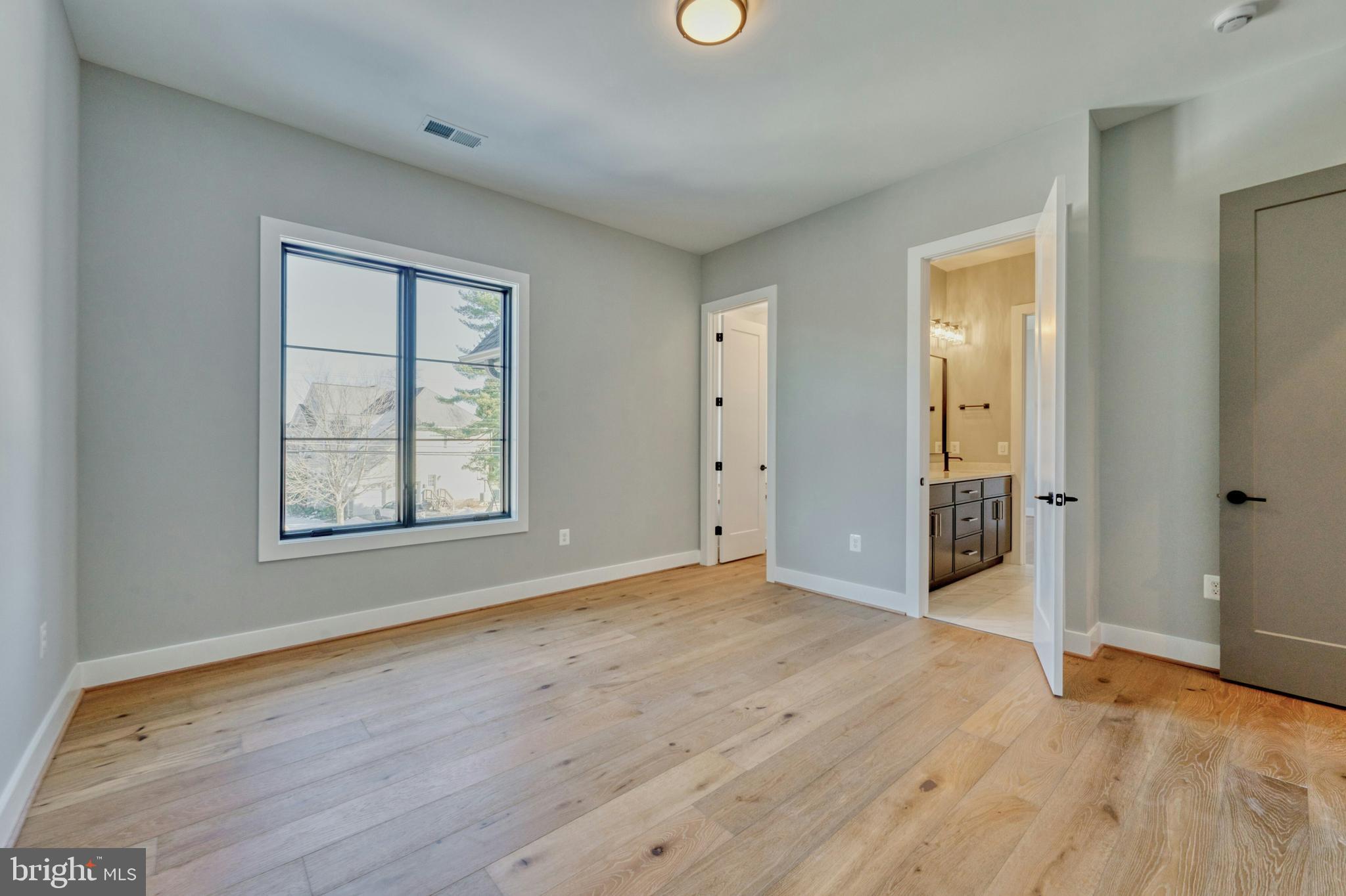 1100 Balls Hill Road McLean, VA 22101 - Photo 40 of 52 an empty room with wooden floor and windows