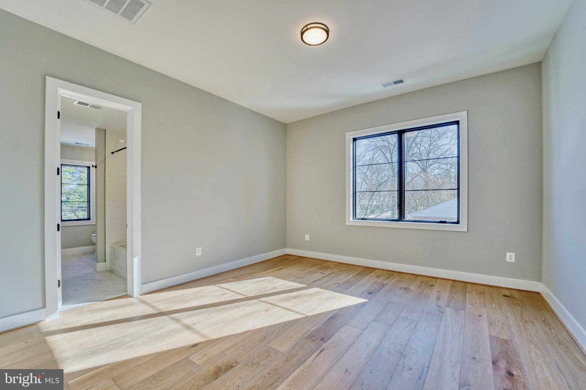 1100 Balls Hill Road McLean, VA 22101 - Photo 43 of 52 an empty room with wooden floor and windows