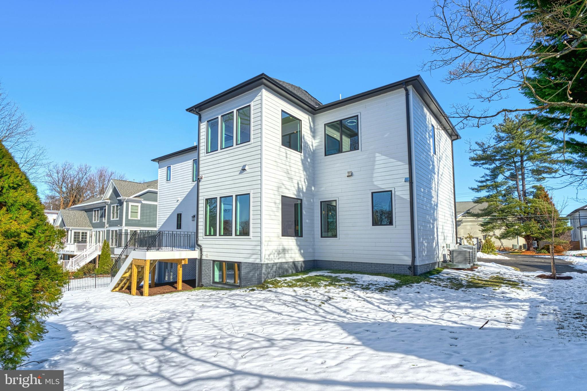 1100 Balls Hill Road McLean, VA 22101 - Photo 52 of 52 a view of a white house with large windows next to a road