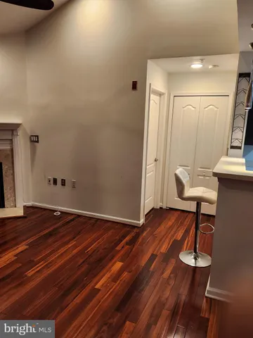 a view of a room with wooden floor and bench
