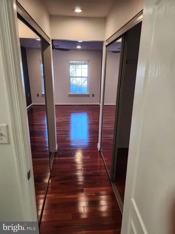 a view of entryway and hall with wooden floor