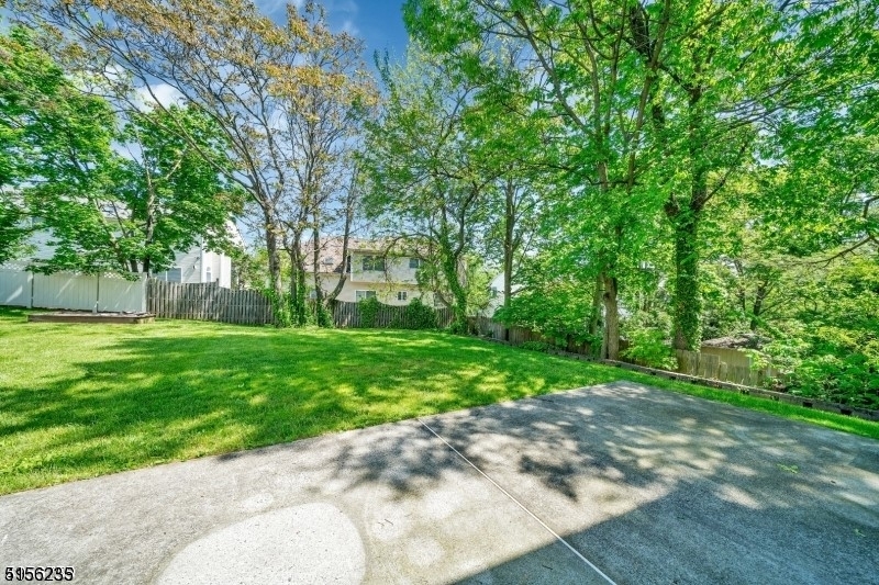 83 Springfield Avenue, Unit A Summit, NJ 07901 - Photo 11 of 14 a view of a backyard with large trees