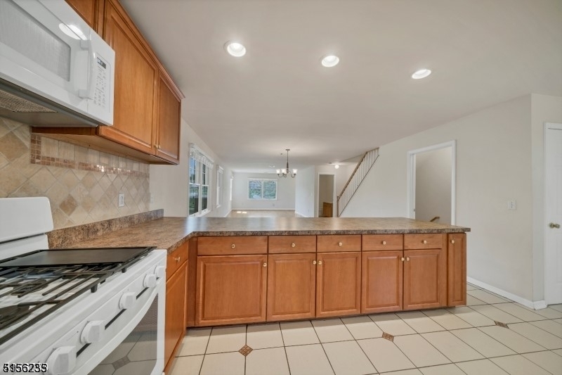 83 Springfield Avenue, Unit A Summit, NJ 07901 - Photo 3 of 14 a kitchen with a stove sink and cabinets