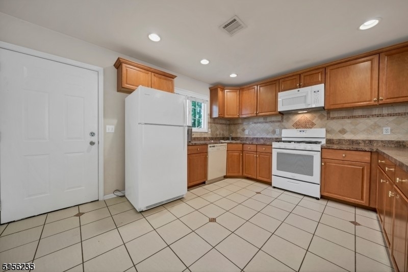 83 Springfield Avenue, Unit A Summit, NJ 07901 - Photo 4 of 14 a kitchen with a sink a counter top space cabinets and stainless steel appliances