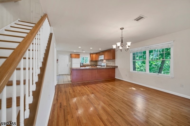 83 Springfield Avenue, Unit A Summit, NJ 07901 - Photo 5 of 14 a view of a kitchen with wooden floor and chandelier