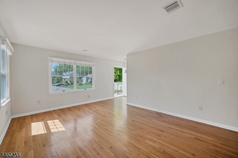 83 Springfield Avenue, Unit A Summit, NJ 07901 - Photo 6 of 14 an empty room with wooden floor and windows
