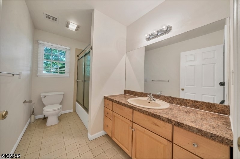 83 Springfield Avenue, Unit A Summit, NJ 07901 - Photo 9 of 14 a spacious bathroom with a granite countertop sink a toilet and a mirror