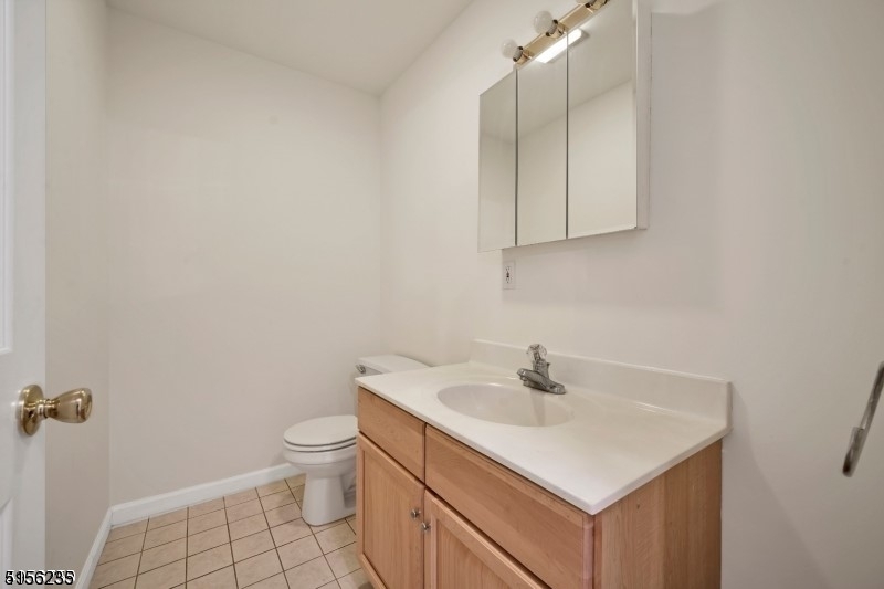 83 Springfield Avenue, Unit A Summit, NJ 07901 - Photo 10 of 14 a bathroom with a sink toilet and vanity