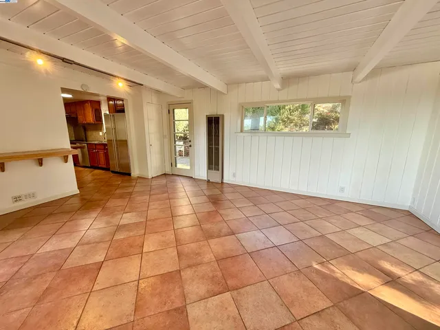 a view of an empty room and a window