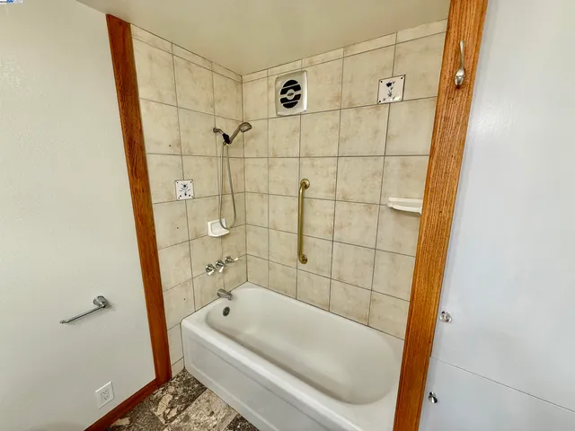 a bathroom with a bathtub and a shower