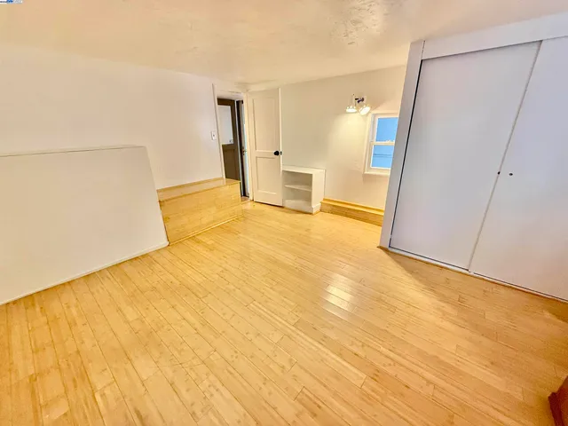 a view of a big room with closet and wooden floor