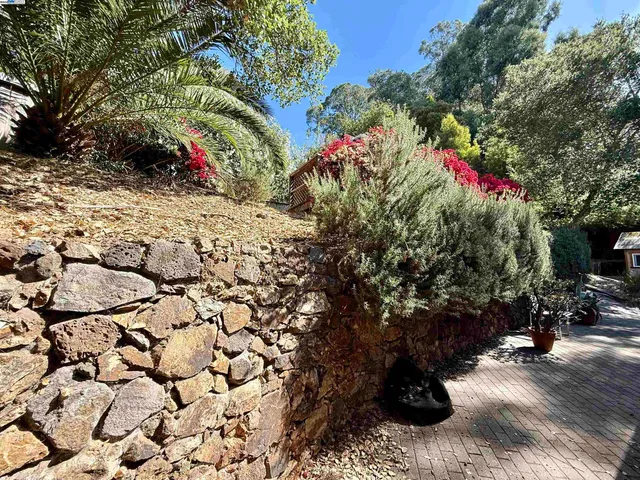 a view of a patio with a table and chairs under an umbrella
