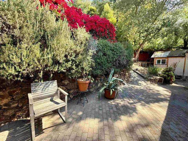 a view of a patio with a table chairs and a backyard