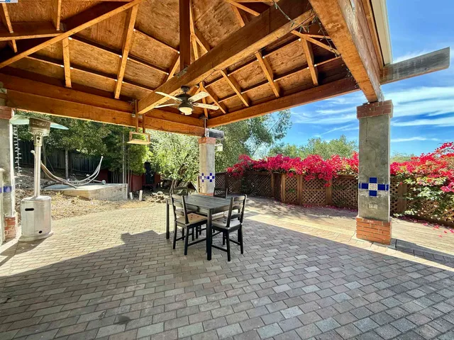 a view of a patio with table and chairs potted plants