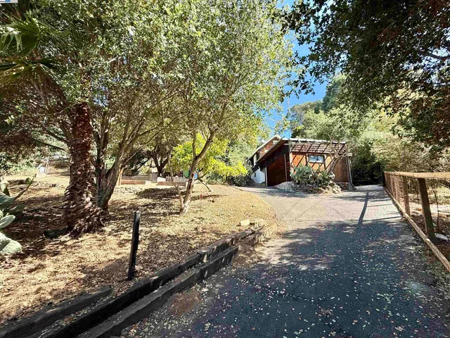 a view of a yard with wooden fence
