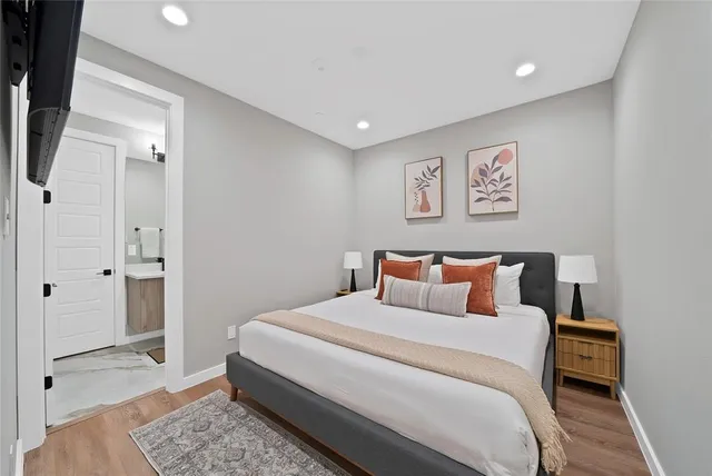 a bedroom with a bed and a painting on the wall