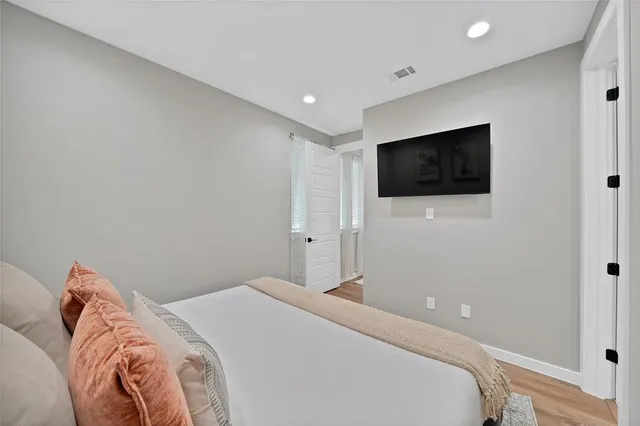 a bedroom with a bed and a flat screen tv