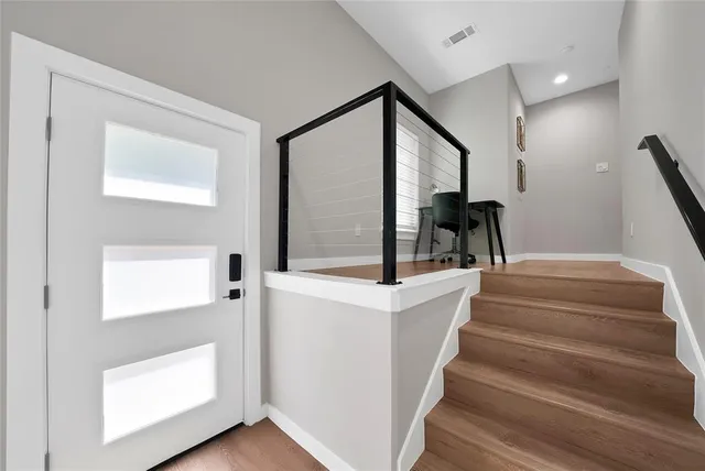 a view of entryway and hall with wooden floor