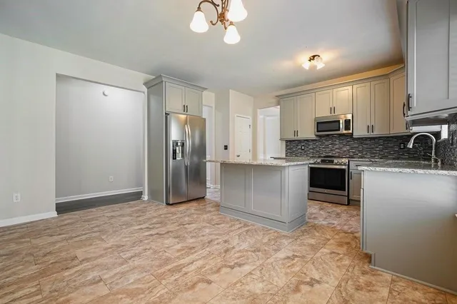 a stove top oven sitting inside of a kitchen