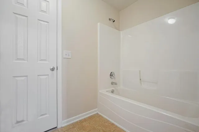 a room with wooden floor and window