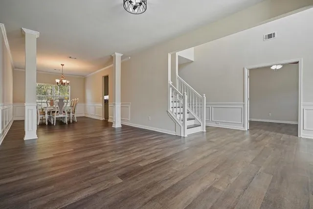 wooden floor in an empty room with a window