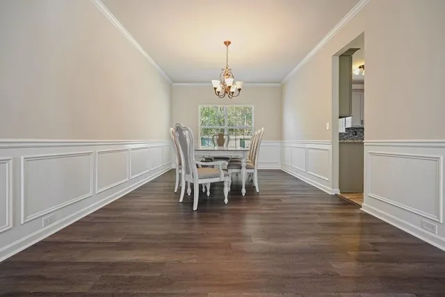 a view of a dining room with furniture and chandelier