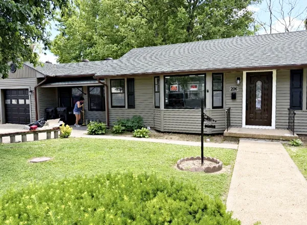 a front view of a house with yard and porch