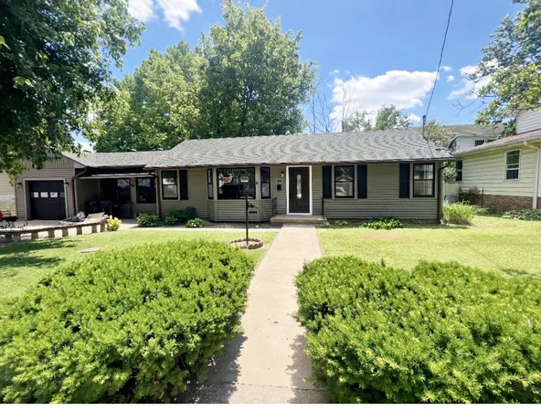 a front view of a house with a yard table and chairs