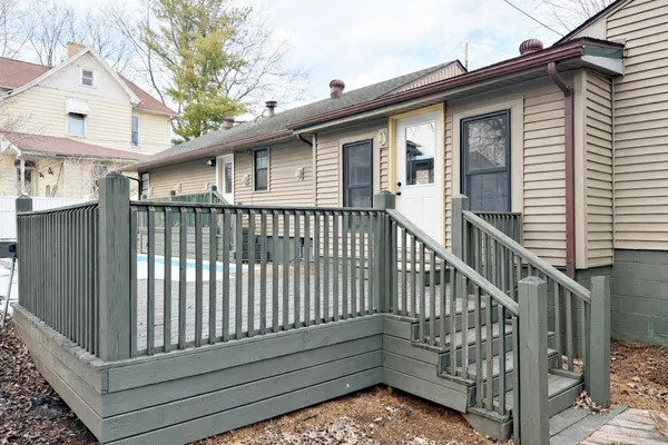 a view of a house with wooden deck
