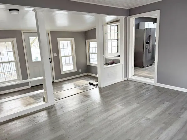 wooden floor in an empty room with a window