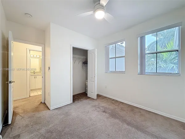 an empty room with windows and closet
