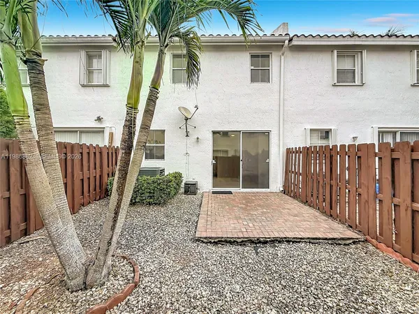a view of a house with wooden fence
