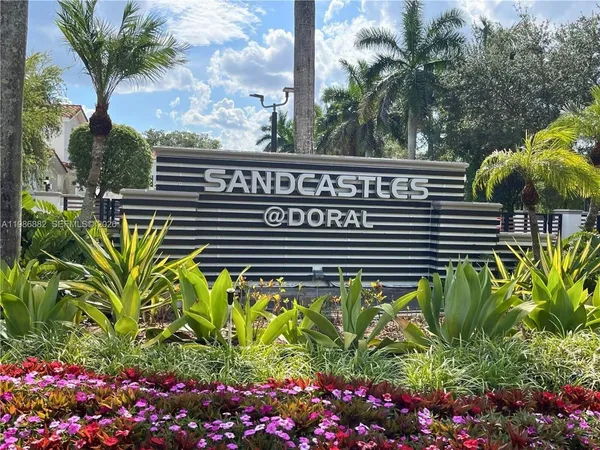 a view of a swimming pool with a flower garden