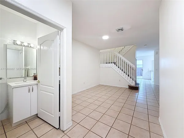 a view of a utility room with closet and windows
