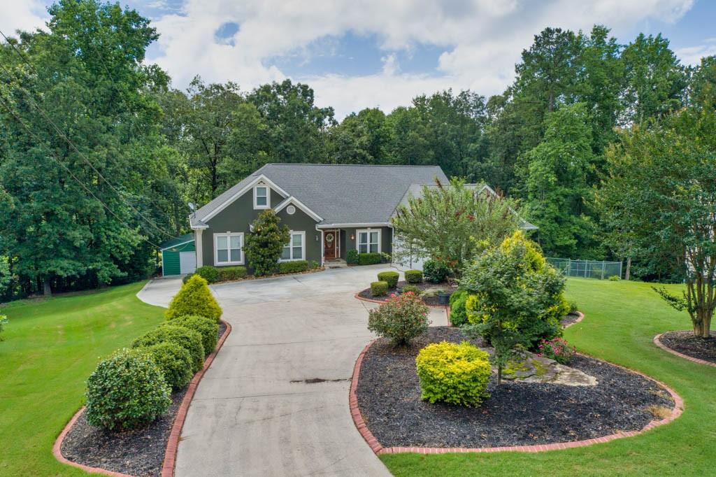 a aerial view of a house with a yard and green space