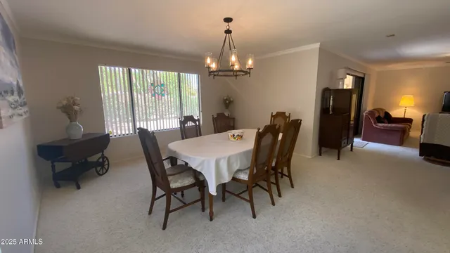 a view of a a dining room with furniture window and wooden floor