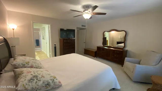 a bedroom with a bed and a mirror