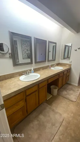 a spacious bathroom with a granite countertop sink a mirror and a