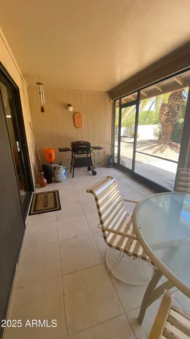 a view of a backyard with potted plants and large trees