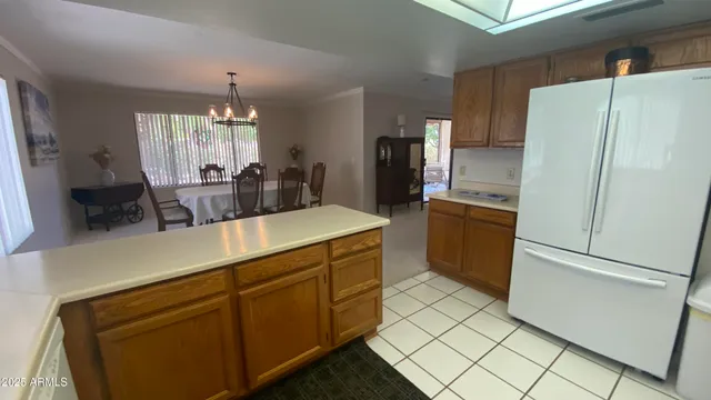 a kitchen with a sink a stove a refrigerator a window and cabinets