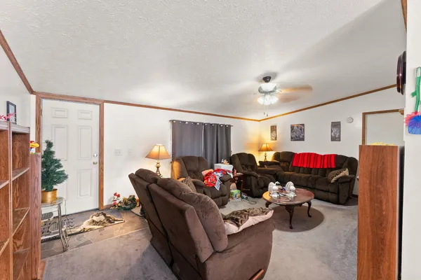 a living room with furniture a air conditioner and a window