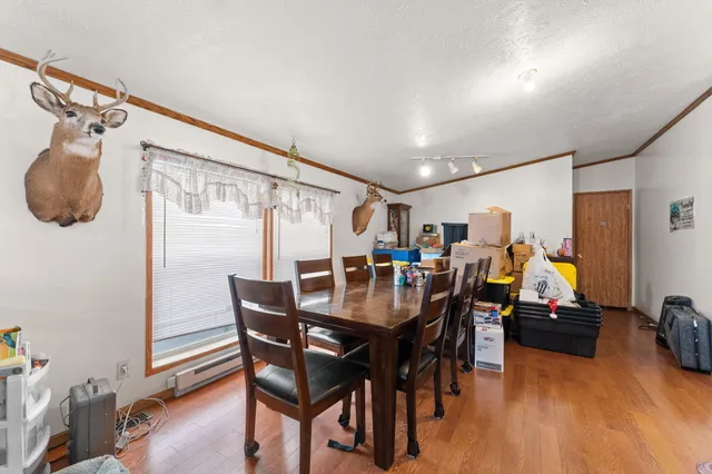 a view of a dining room with furniture large window and wooden floor