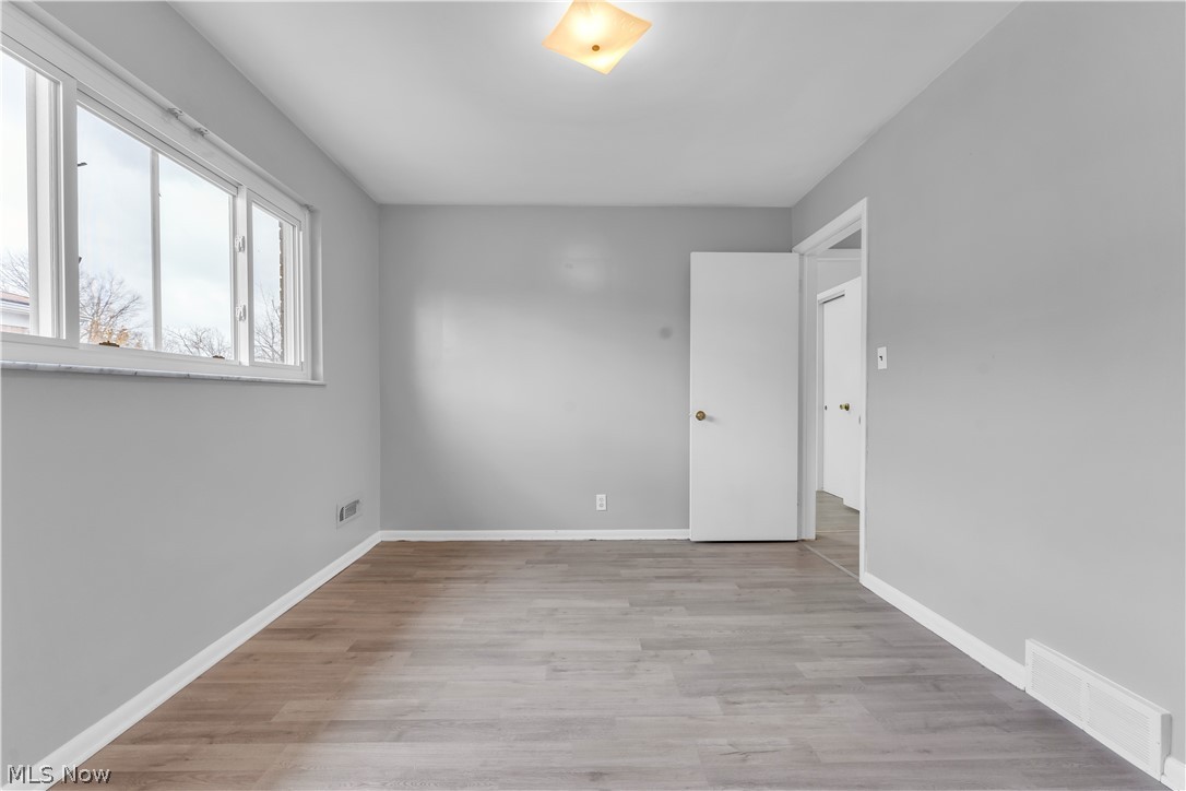 2915 Snow Road, Unit 2/UP Cleveland, OH 44134 - Photo 12 of 23 Neutral wall paint, wood-finish flooring, white baseboards, and a multi-pane window