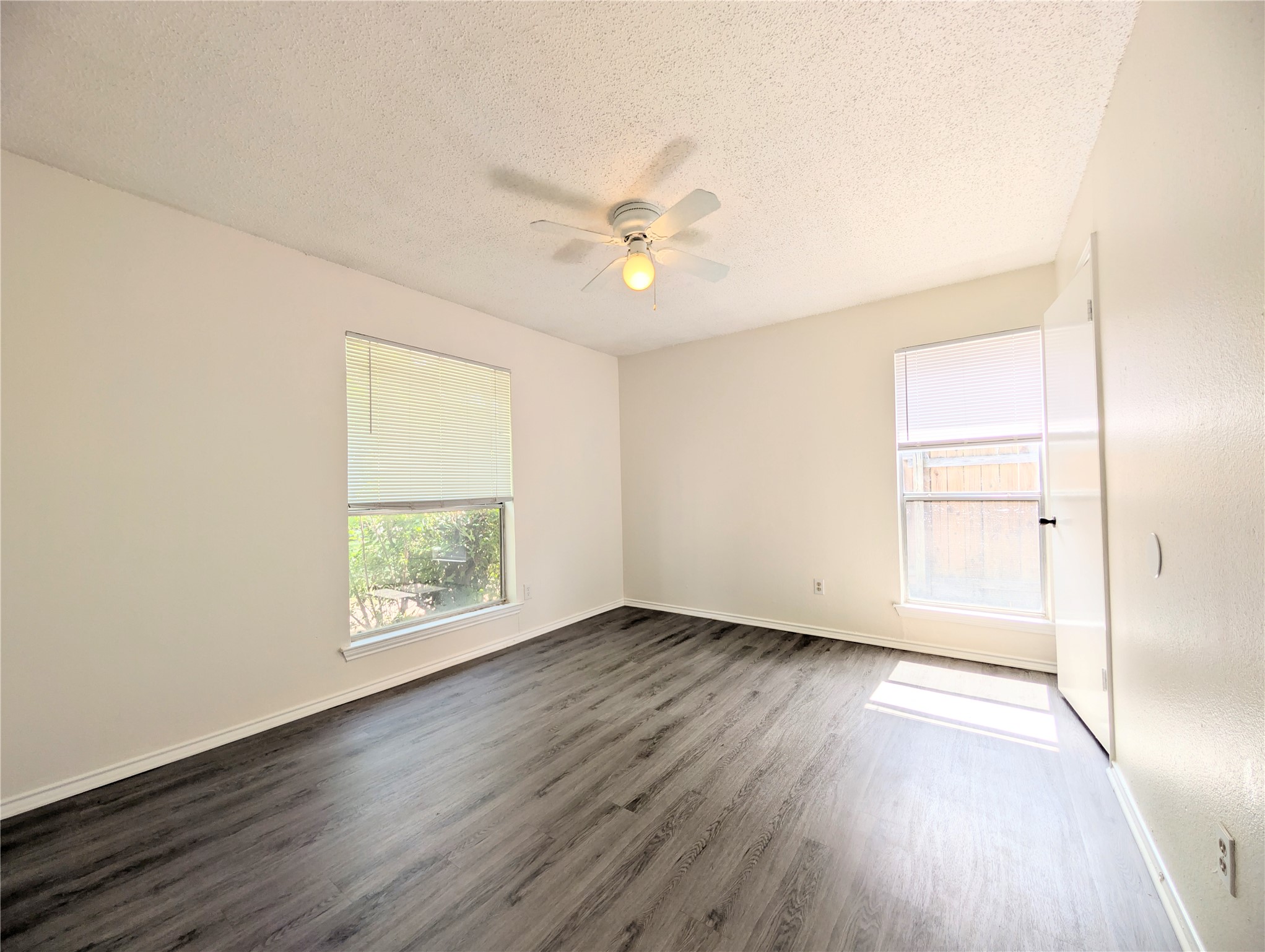 2036 Redwing Way Round Rock, TX 78664 - Photo 14 of 23 Bedroom #2
A well-lit bedroom features durable laminate flooring and a ceiling fan for comfort.